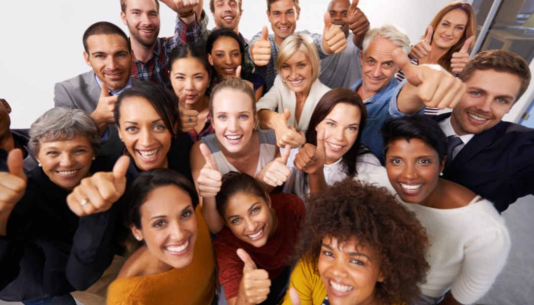 People smiling with thumbs up
